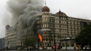 Taj Mahal hotel is seen engulfed in smoke during gun battle in Mumbai